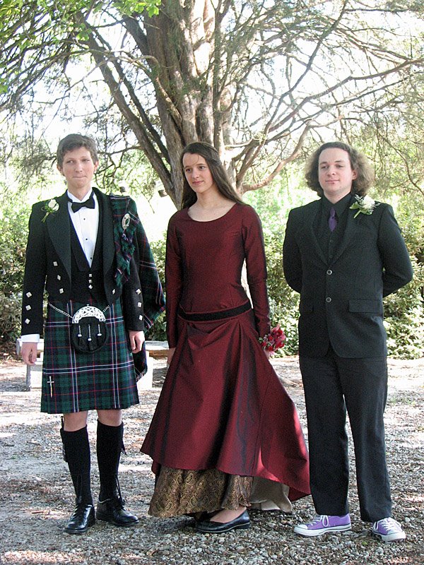 Two boys and a girl dressed up for Prom.