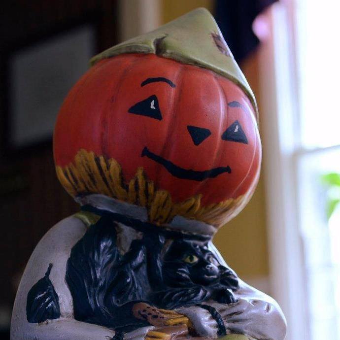 A ceramic Pumpkin Headed scarecrow. Fall Decoration.