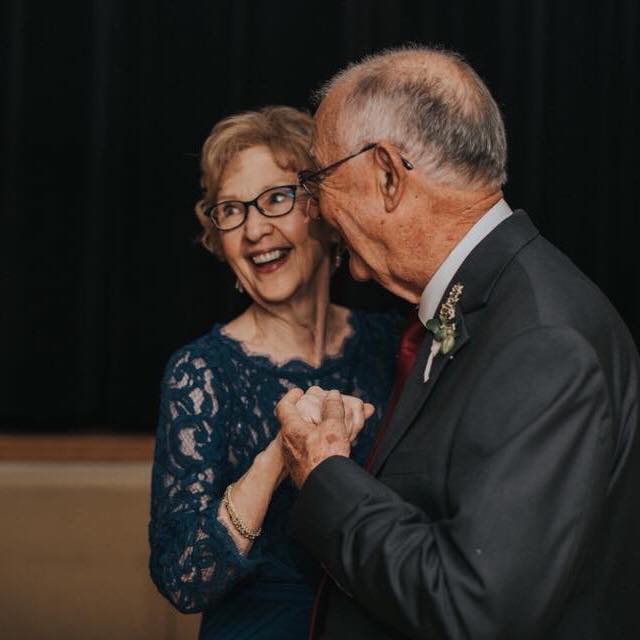 A couple in their 80s dancing at a wedding.